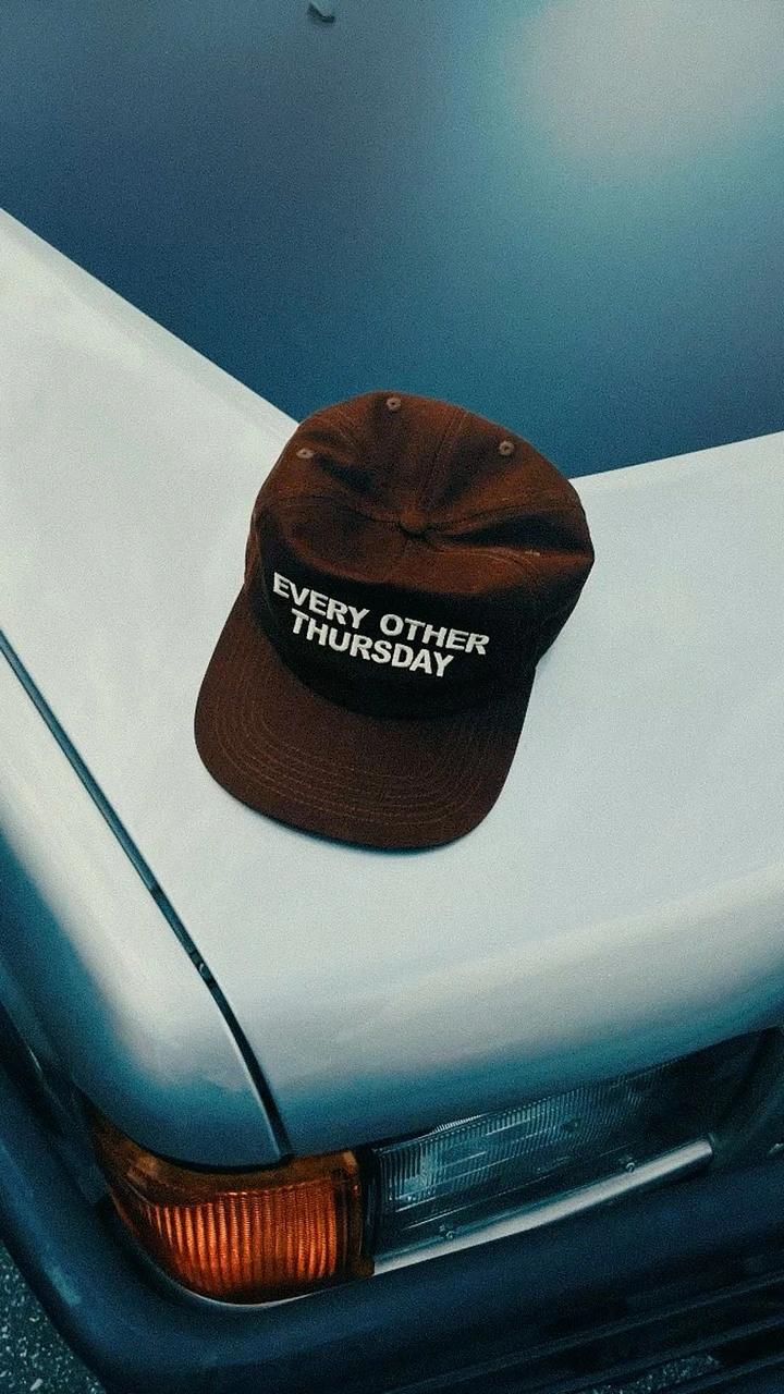 Hats & Caps creative ad: Cap placed on car with witty copy