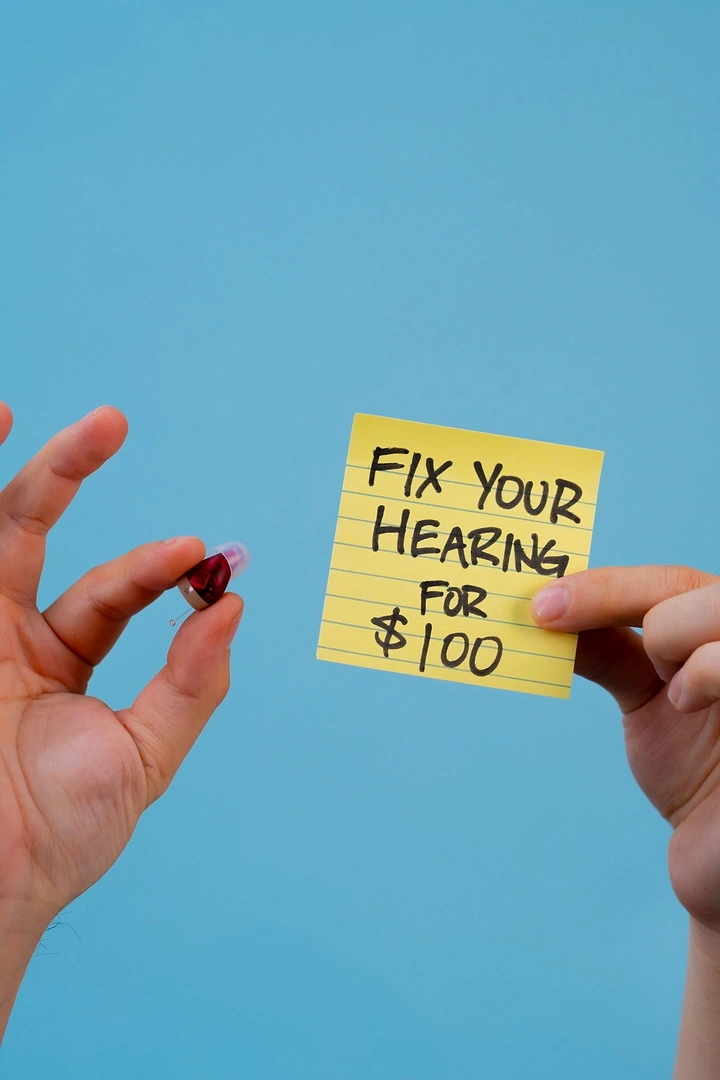 Hearing Aids creative ad: Sticky-note price offer, tiny aid held