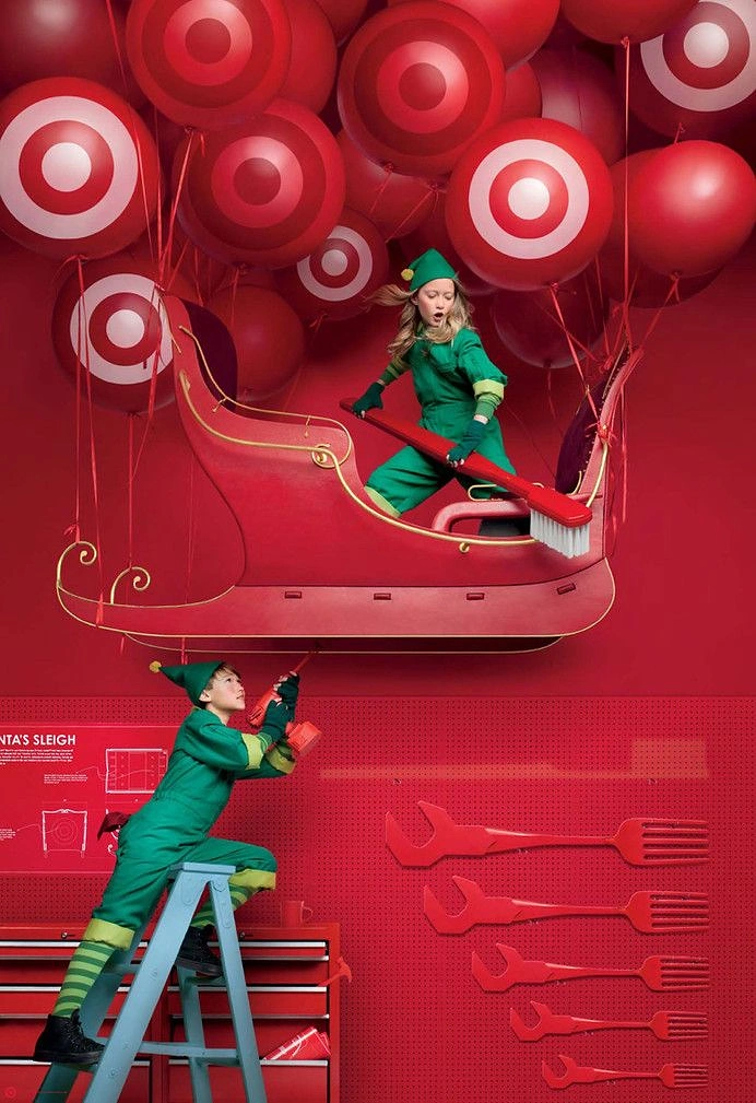 Christmas creative ad: Child elves repairing Santa's sleigh lifted by bullseye balloons