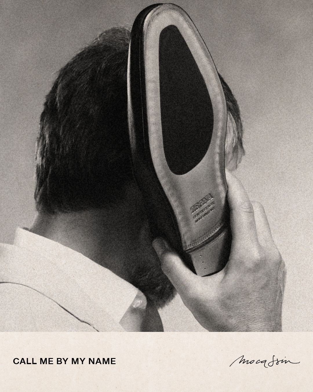 Man holding a leather shoe sole to his ear like a phone