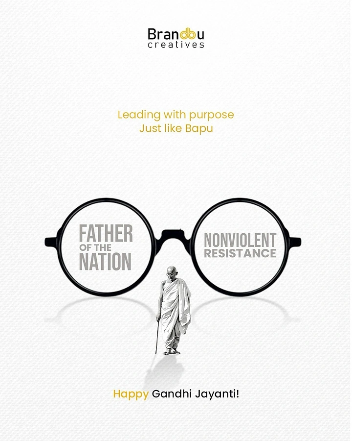 Gandhi Jayanti creative ad: Oversized round spectacles with a small Gandhi figure walking beneath
