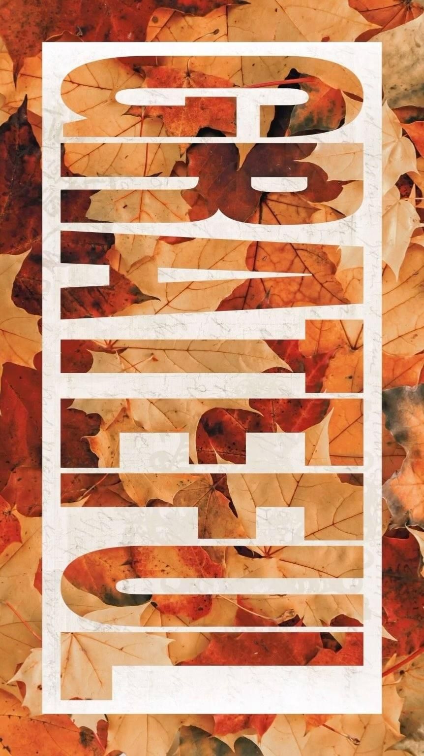 Knocked-out vertical word over a bed of autumn leaves
