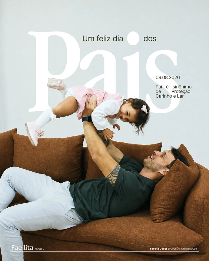 Father's Day creative ad: Father lying on a rust sofa lifting his laughing baby daughter overhead