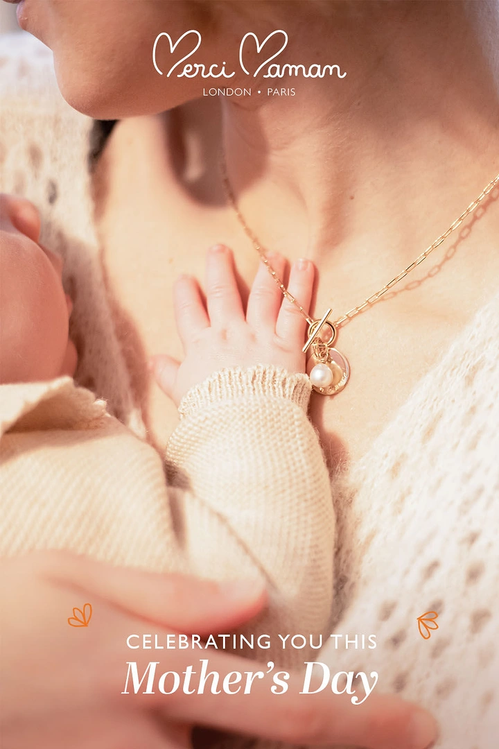 Mother's Day creative ad: Baby's hand on mother's chest by pearl necklace