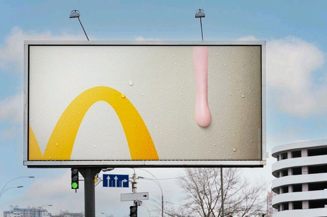 Banner: Cropped golden arch beside a pink shake drip on a frosty surface