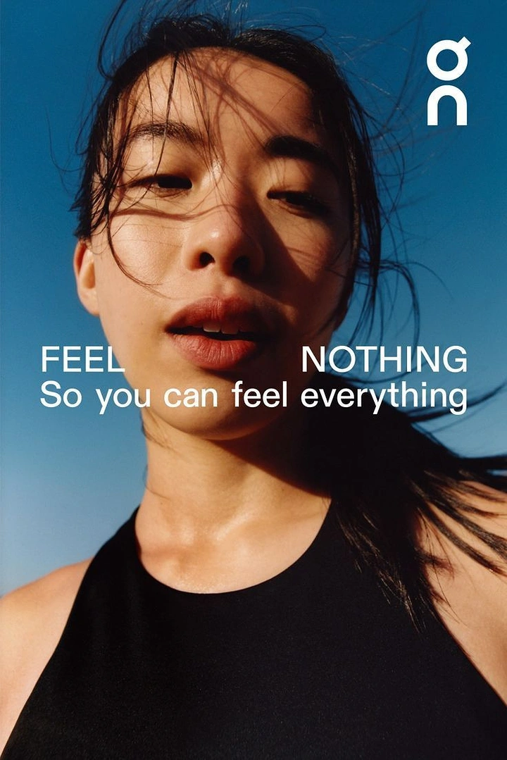 Creative ad: Low-angle close-up of a sweaty female runner against clear blue sky