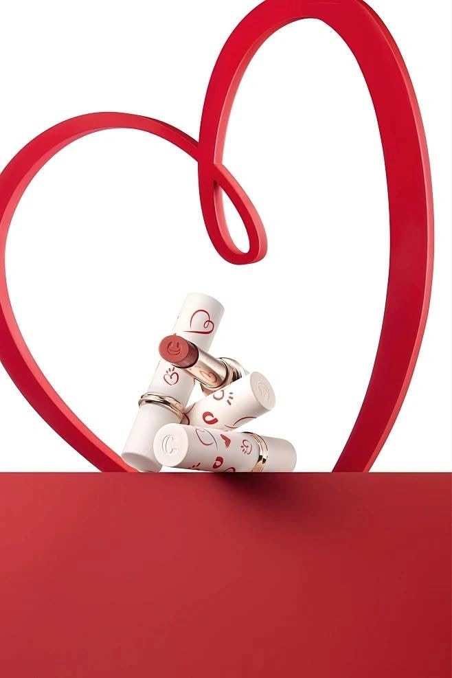 Valentine's Day creative ad: Heart-printed white lipsticks framed by a red looped heart