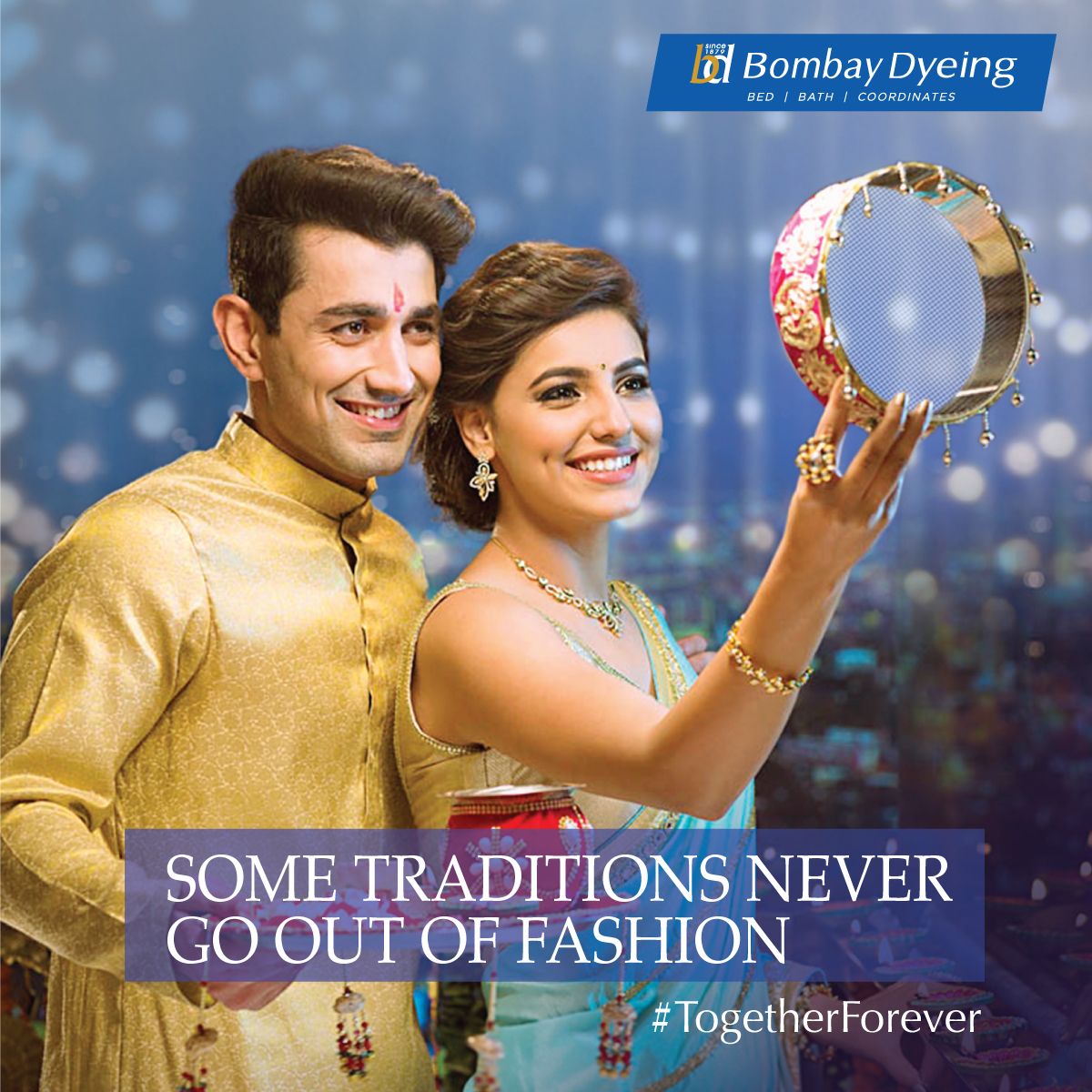 Smiling couple, woman holding up decorated Karwa Chauth sieve