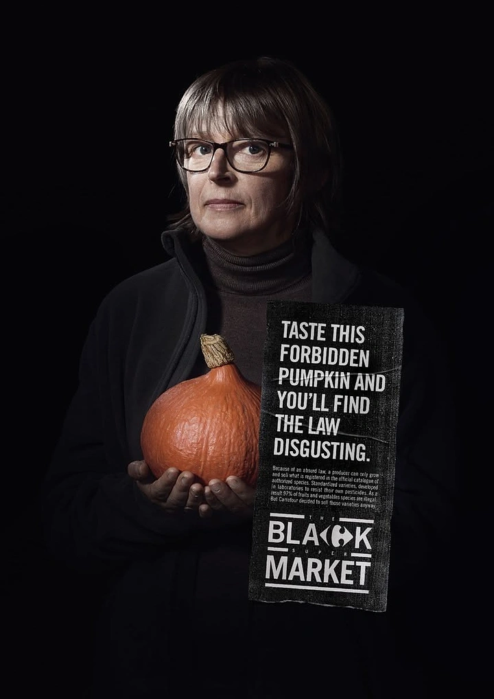 Organic & Farm Produce creative ad: Woman holding a red kuri pumpkin against black