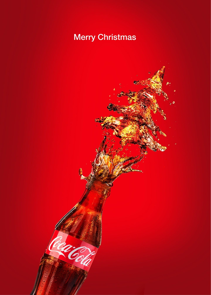 Christmas creative ad: Cola splash forming a Christmas tree from a bottle