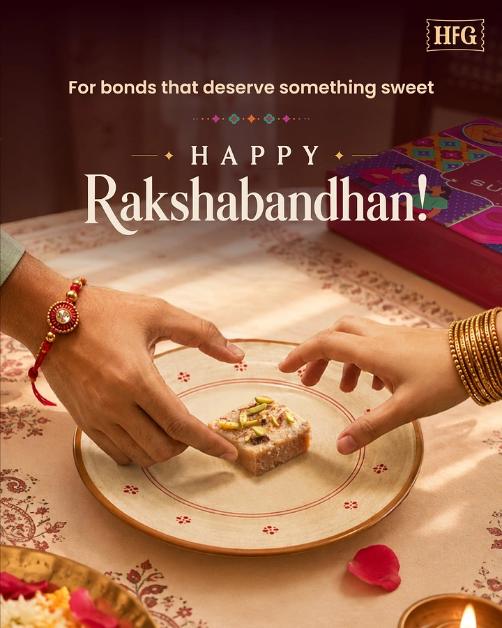 Raksha Bandhan creative ad: Brother's and sister's hands reaching for one barfi on a plate