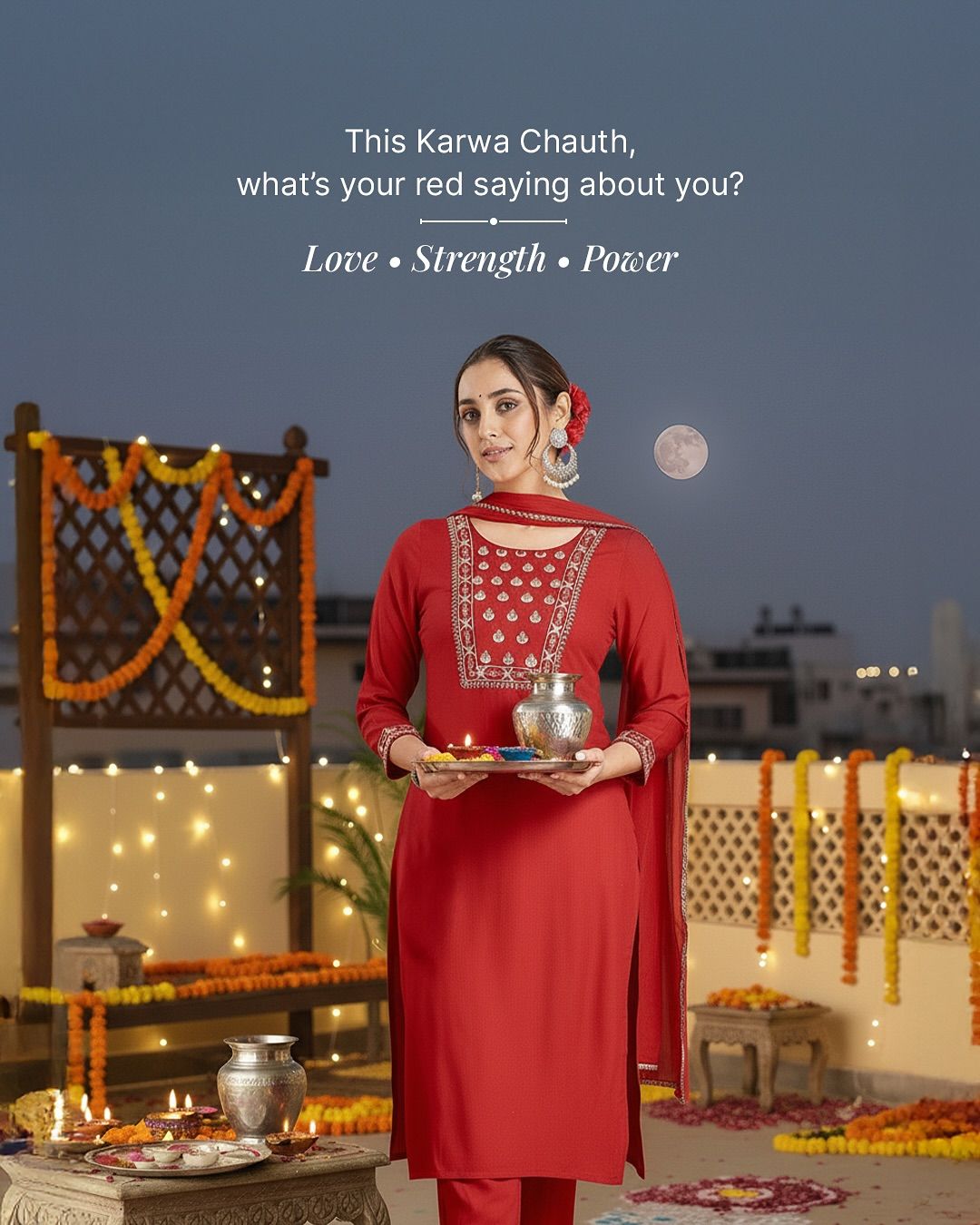 Woman in red embroidered kurta holding puja thali