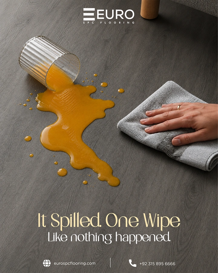 Wooden & Vinyl Flooring creative ad: Orange juice spilled from a ribbed glass on grey SPC flooring, being wiped
