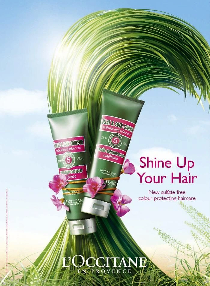 Hair Care Brands creative ad: Two green shampoo and conditioner tubes tied with twine and pink flowers against a huge wave of grass shaped like hair