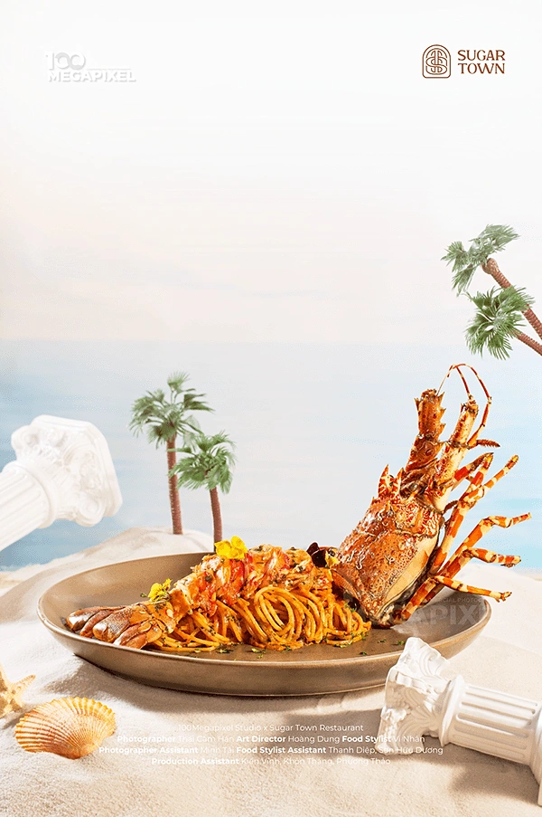 Seafood Restaurants creative ad: Lobster pasta staged as beachside fantasy