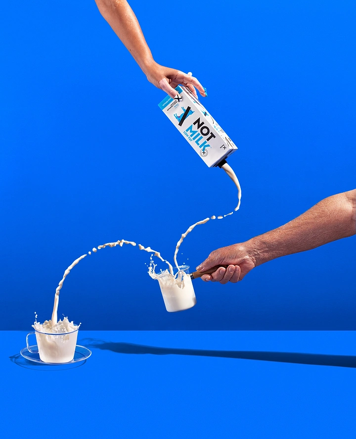 Dairy Brands creative ad: Long-distance pour, playful stunt composition