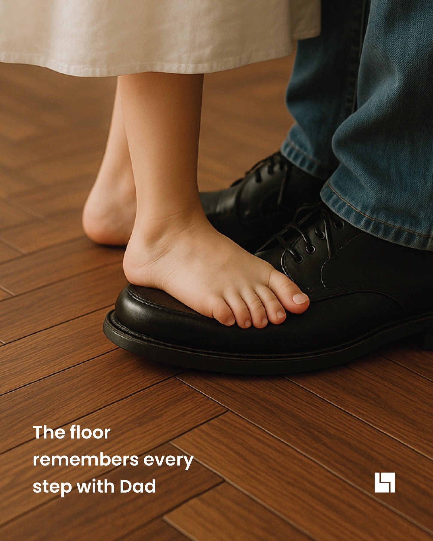 Child's bare feet standing on father's black shoes on a wooden floor