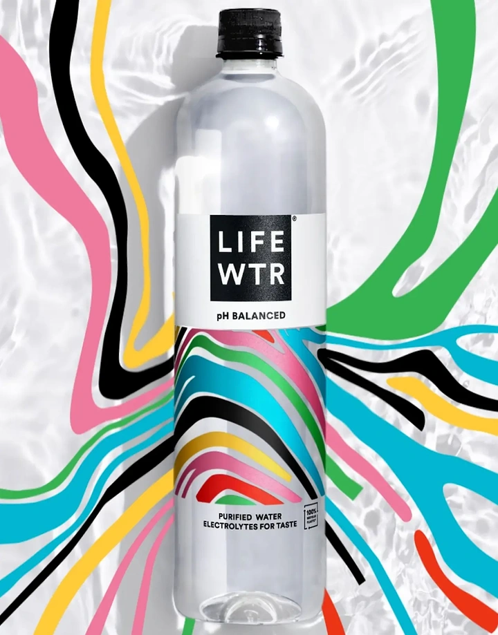 Packaged Drinking Water creative ad: Clear water bottle with art label on rippling water