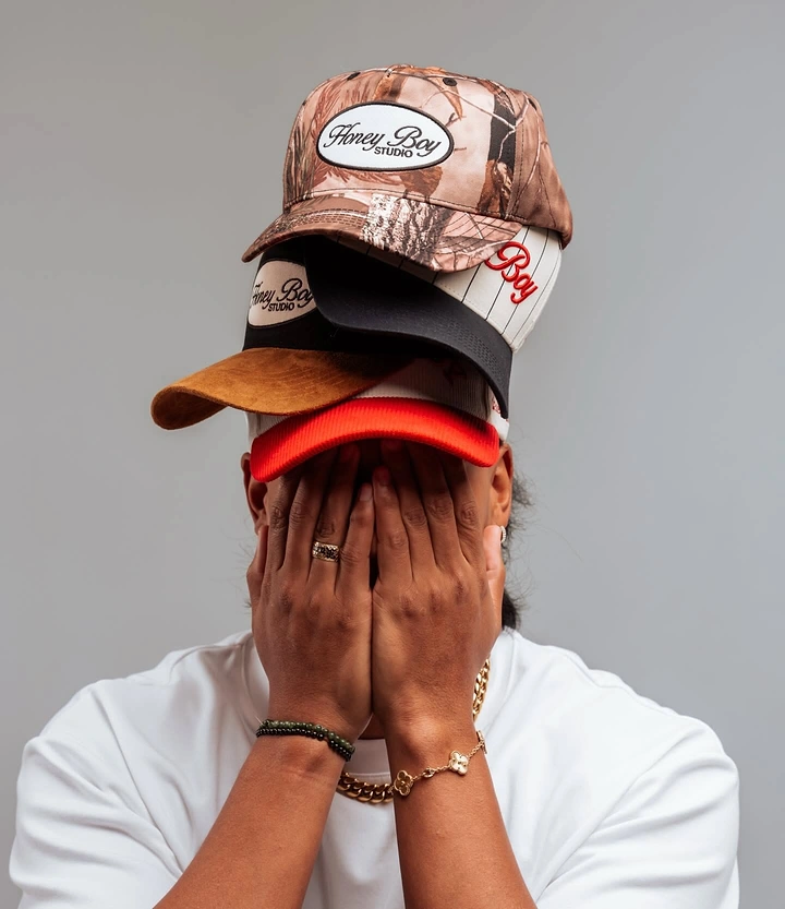 Hats & Caps creative ad: Stacked caps create playful face-covering idea