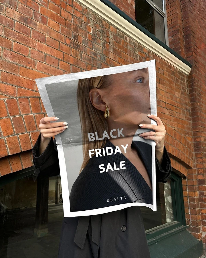 Black Friday creative ad: Person holding a printed half-face portrait in front of their own face