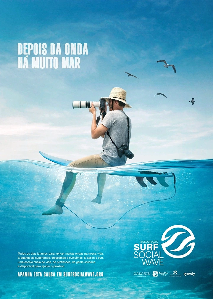 Nonprofit & Social Cause creative ad: Photographer sitting on a surfboard at the half-submerged waterline