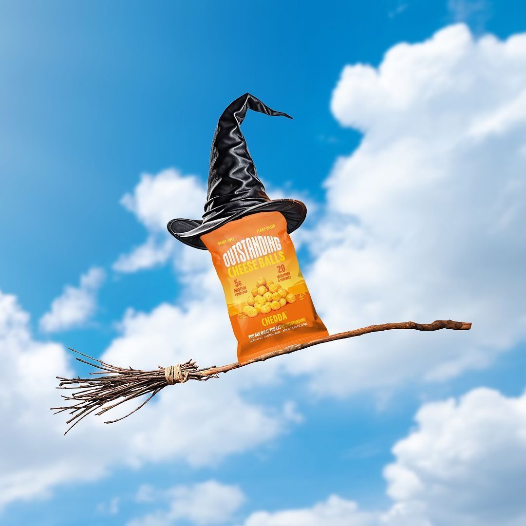 Snack bag wearing a witch hat riding a broomstick in the sky