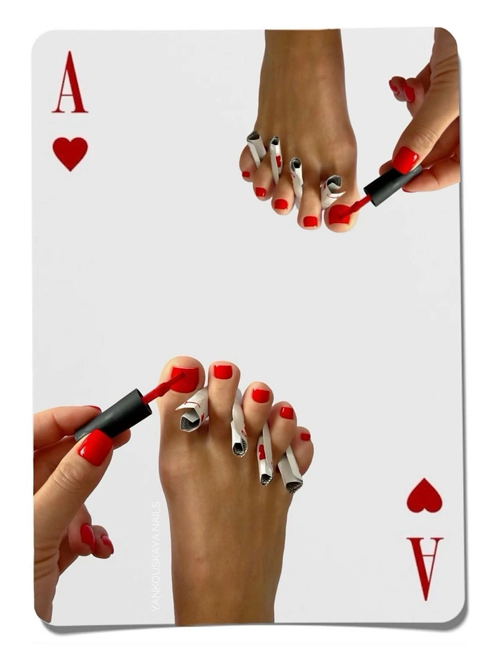 Nail Salons creative ad: Mirrored feet getting red pedicure styled as ace of hearts card
