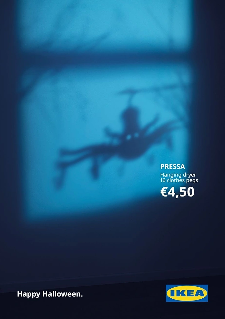Halloween creative ad: Shadow of a hanging clothes-peg dryer that looks like a giant spider