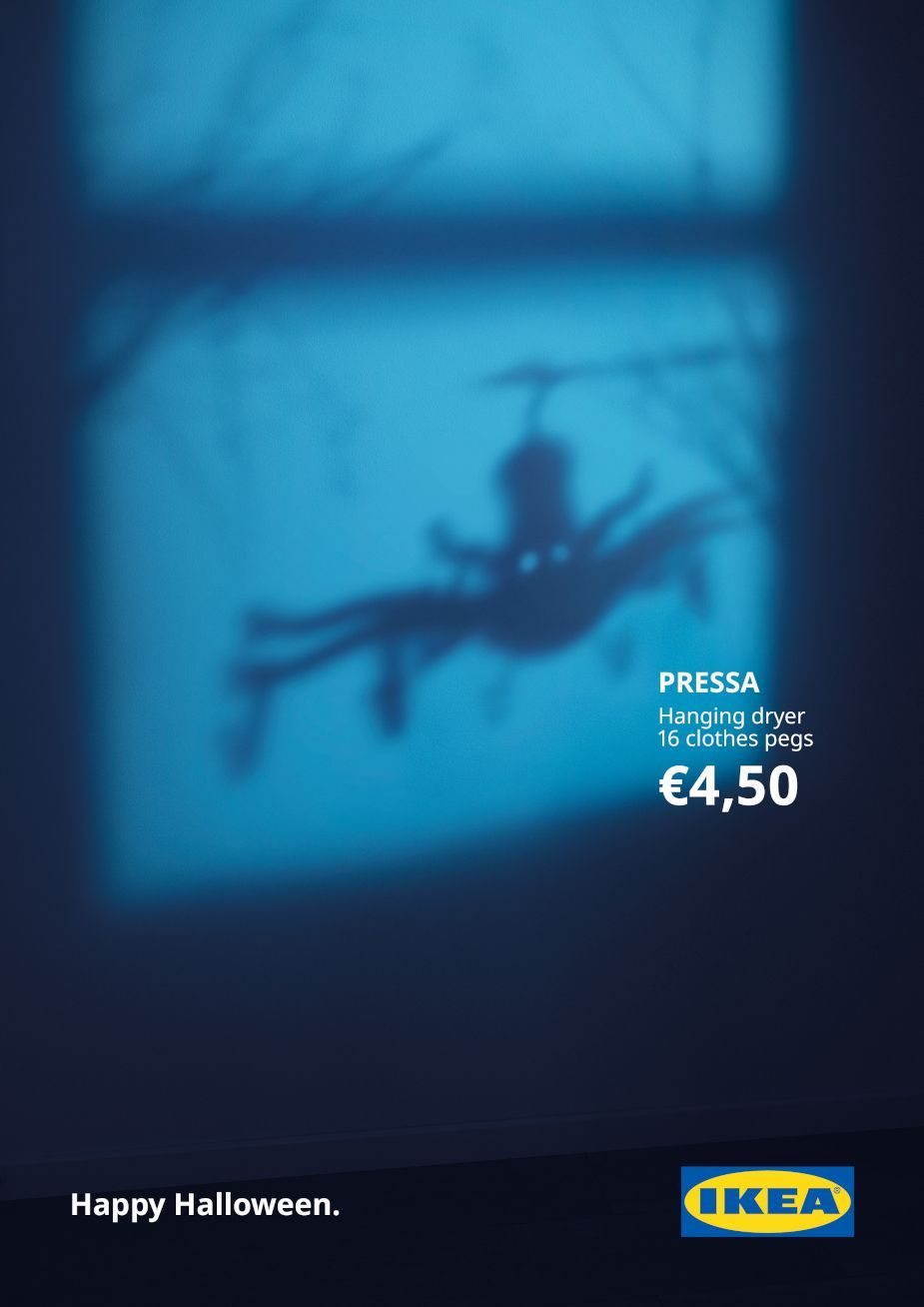 Shadow of a hanging clothes-peg dryer that looks like a giant spider