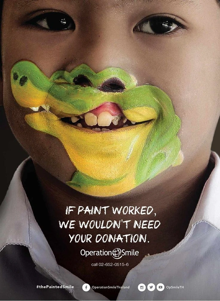 Creative ad: Close-up of a child with crocodile face paint around the mouth