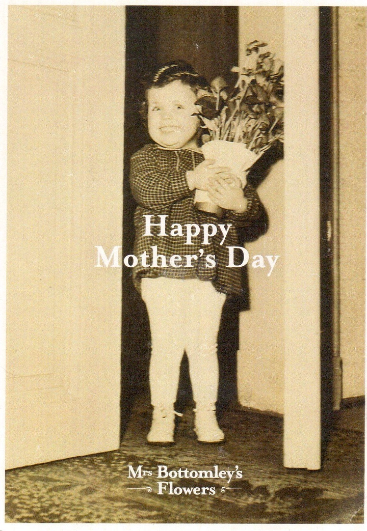 Mother's Day creative ad: Vintage photo of toddler holding a bouquet in a doorway