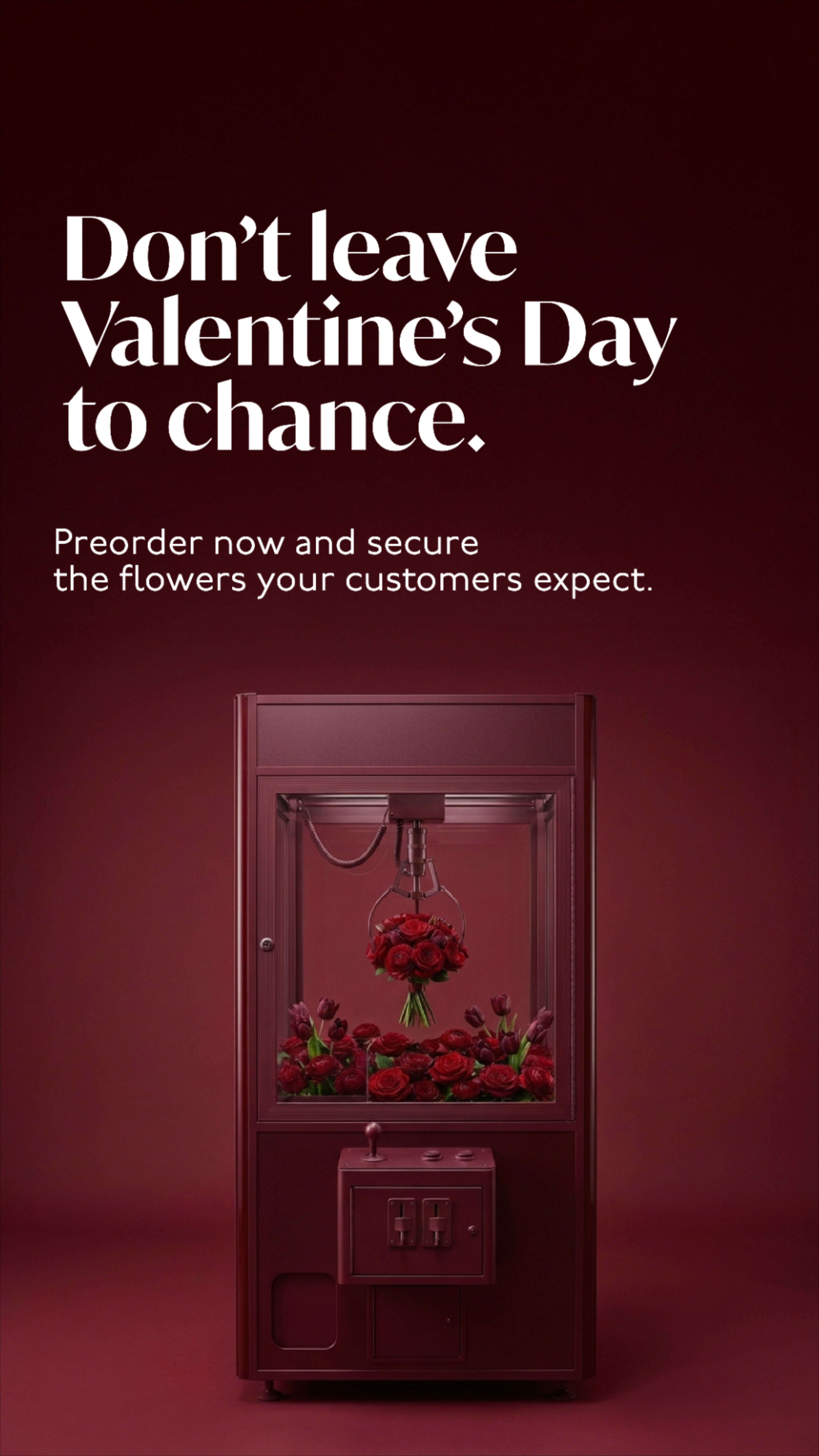 Burgundy claw-crane arcade machine filled with roses