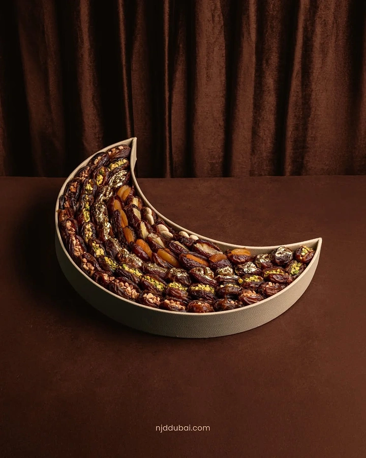 Ramadan creative ad: Crescent-shaped leather tray filled with stuffed dates