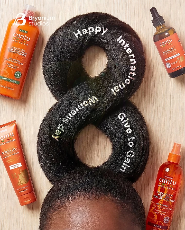 Women's Day creative ad: Afro hair twisted into a figure 8 above a woman's forehead