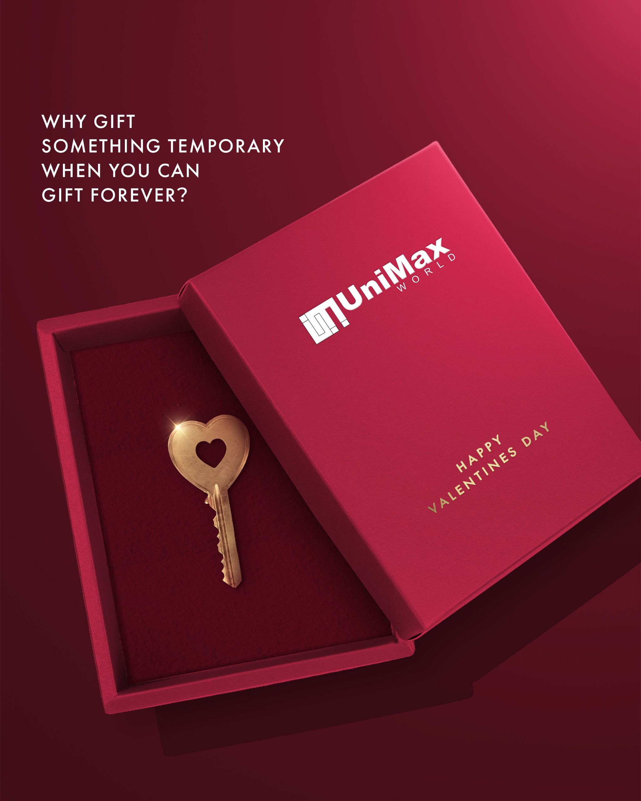 Open crimson gift box holding a gold heart-shaped key