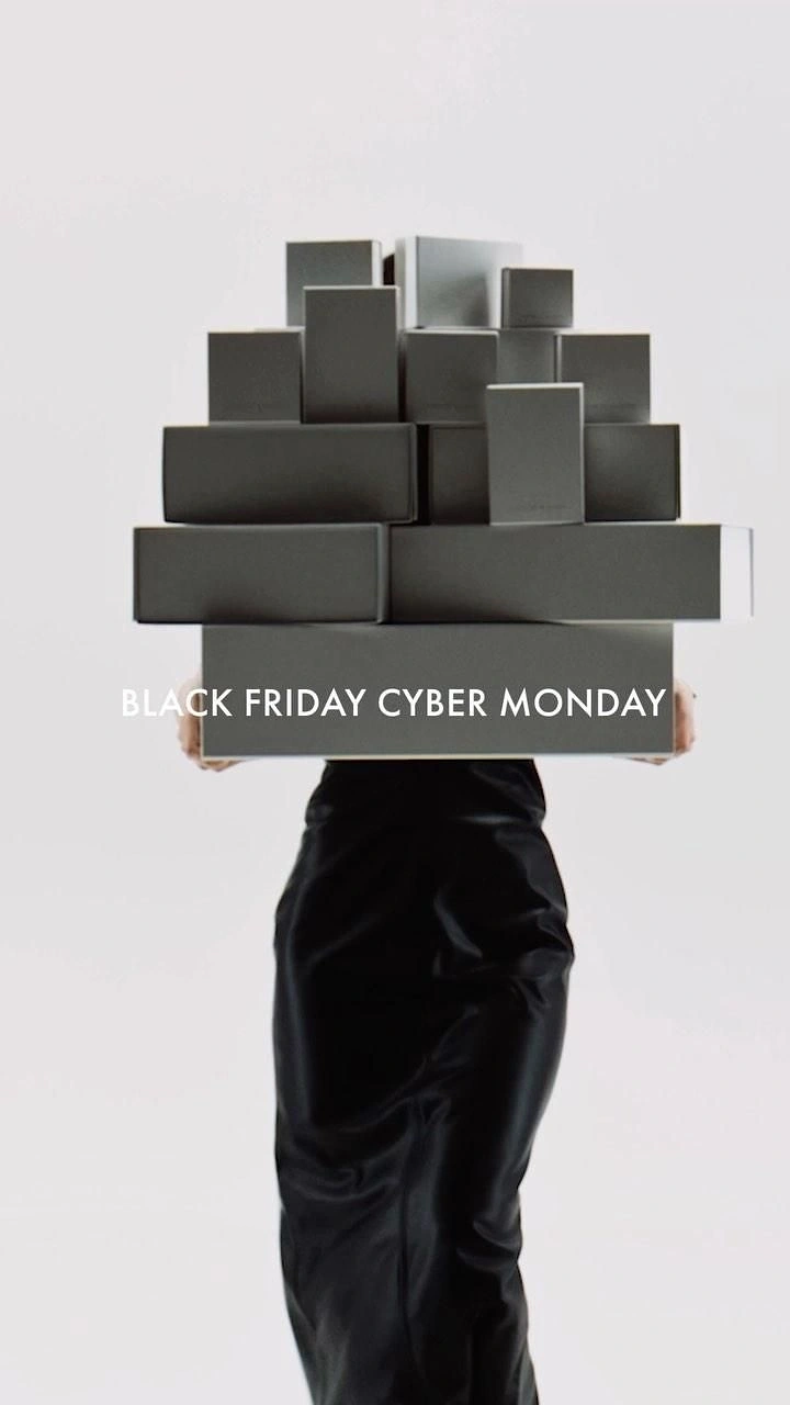 Black Friday creative ad: Model carrying a tall pyramid of grey boxes that hides her upper body