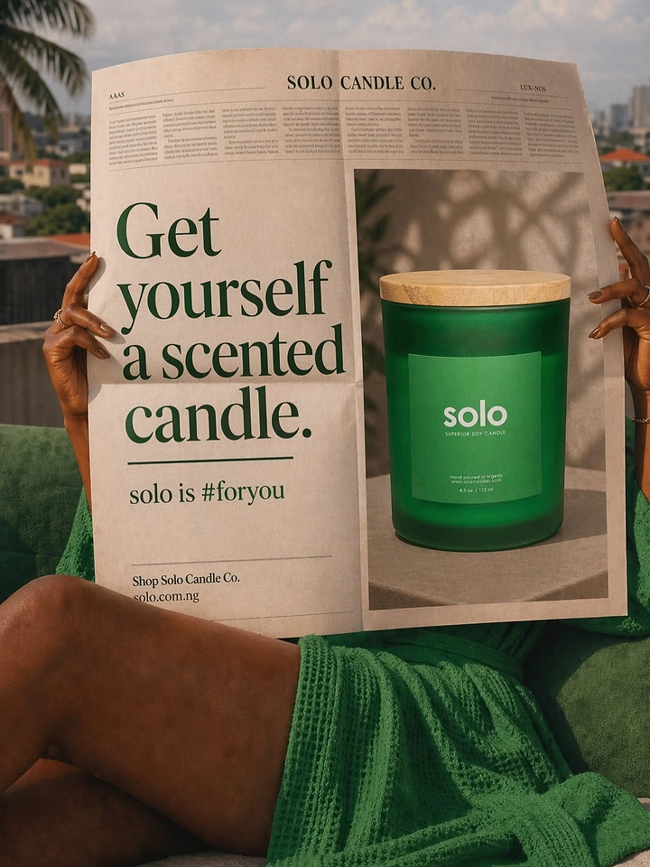 Candles & Home Fragrance creative ad: Woman holding a newspaper ad showing a green candle jar