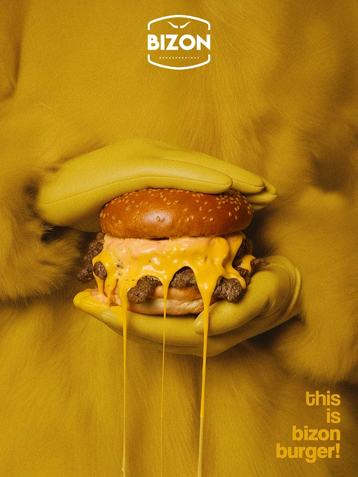 Fast Food creative ad: Mustard-gloved hands holding a dripping cheeseburger against a fur coat