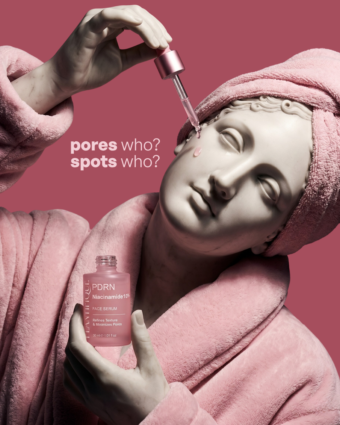 Classical marble statue in a pink bathrobe and towel turban applying serum with a dropper