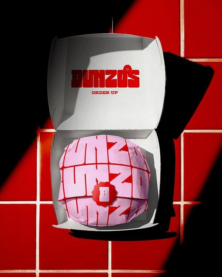 Fast Food creative ad: Open burger box with wrapped branded burger, top-down
