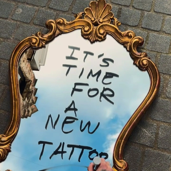 Tattoo Studios creative ad: Message scrawled on ornate mirror reflecting sky