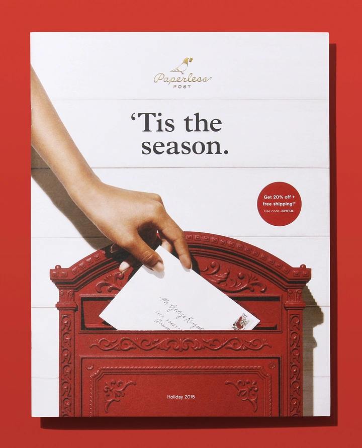 Christmas creative ad: Hand dropping a letter into an ornate red mailbox