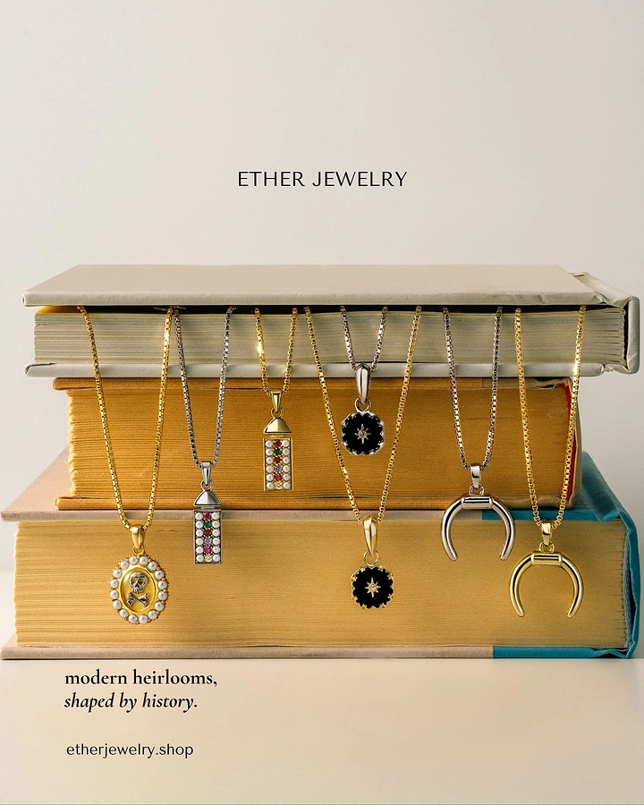 Creative ad: Row of pendant necklaces draped over a stack of old gilt-edged books