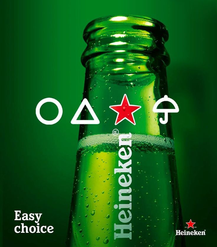 Close-up of green beer bottle neck with pop-culture shape icons