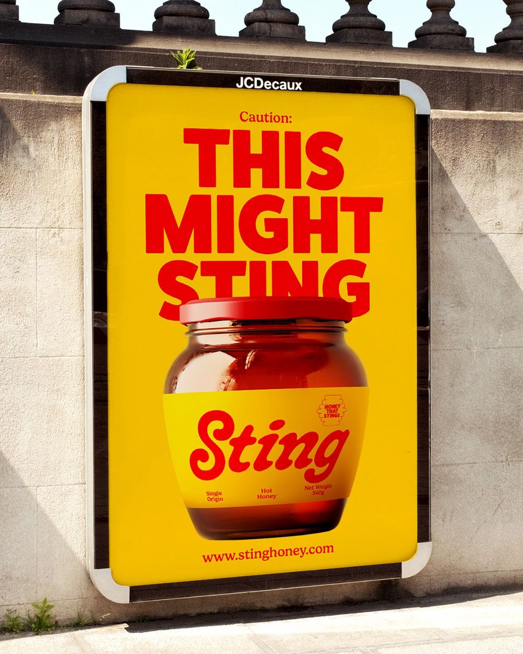 Poster: Amber hot-honey jar with a red lid partly covering a big headline