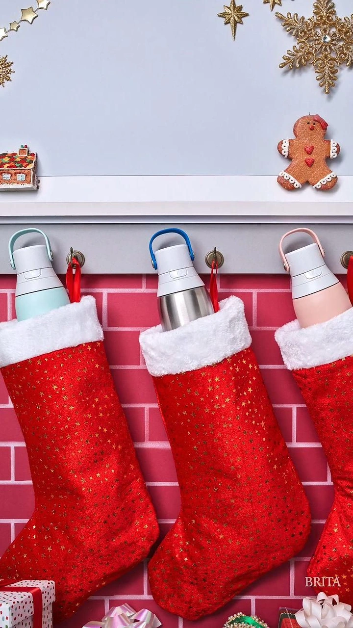 Christmas creative ad: Three water bottles tucked into red Christmas stockings hung on a mantel