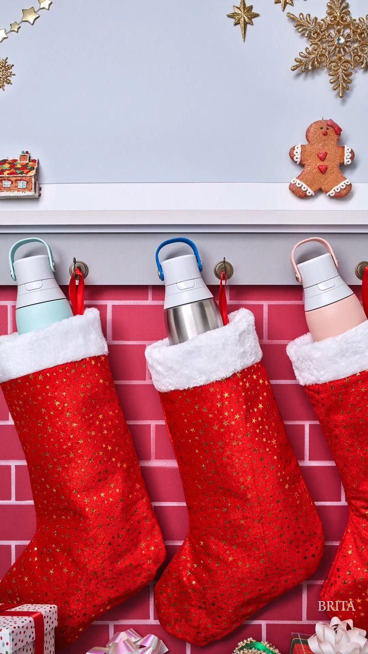 Christmas Story: Three water bottles tucked into red Christmas stockings hung on a mantel