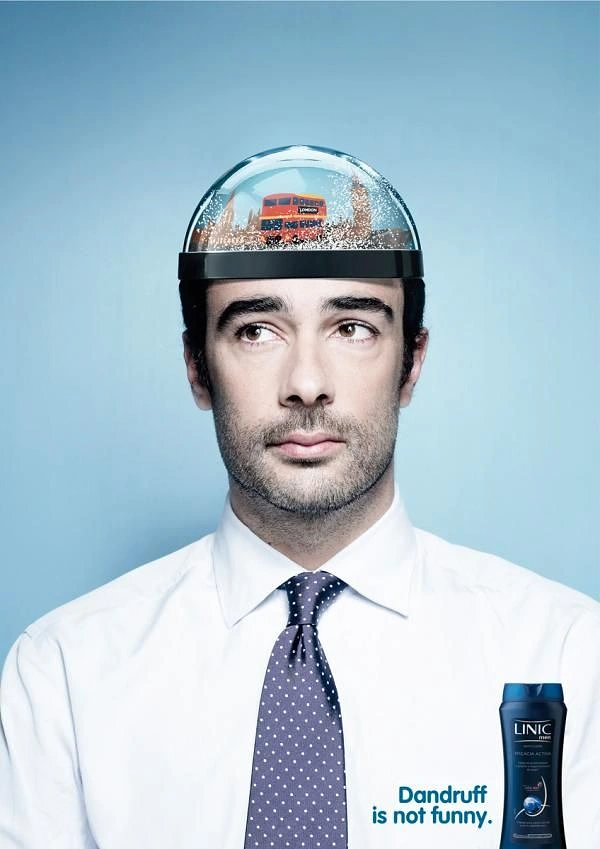 Men's Grooming Brands creative ad: Man whose head top is a snow globe with a London bus inside, as a visual joke about dandruff