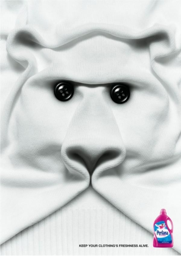 Poster: White knit sweater folded into a polar bear face with button eyes