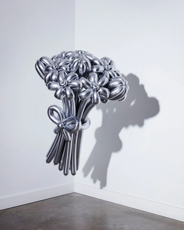 Balloon & Party Decorators creative ad: Silver chrome twisted-balloon flower bouquet mounted in a gallery corner